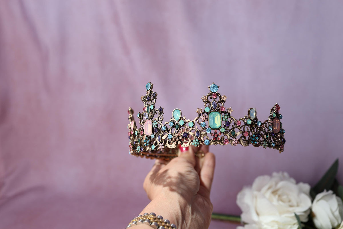 a woman holding a tiara in her hand