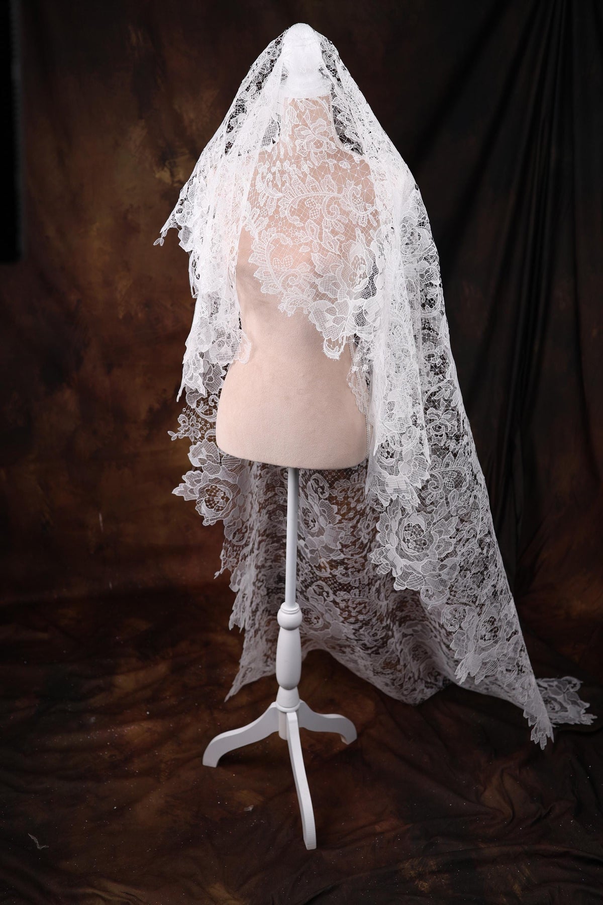 a mannequin with a white veil on top of it