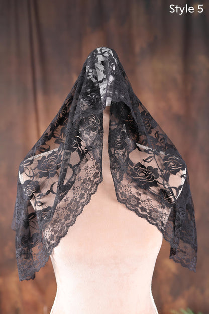 a mannequin wearing a black lace scarf