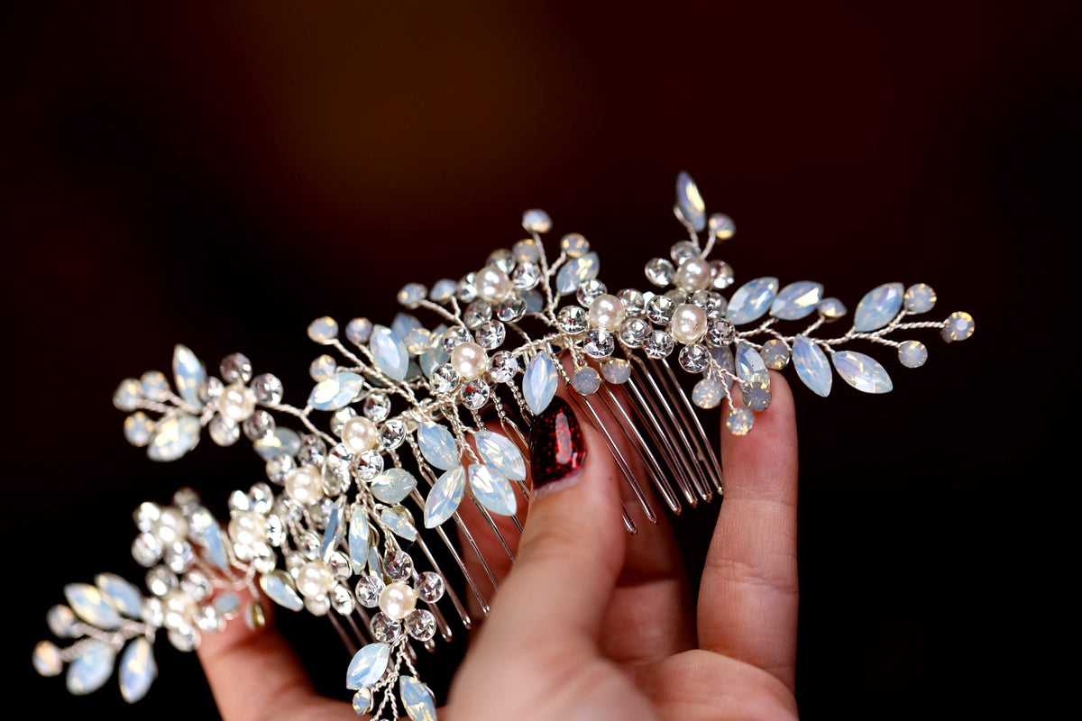 a close up of a person holding a hair comb