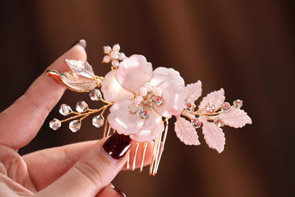a hand holding a hair comb with flowers on it