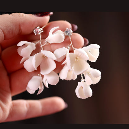 a person holding a bunch of flowers in their hand
