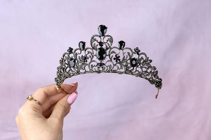 a woman holding a tiara in her hand