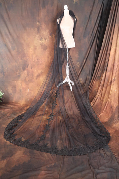 a mannequin's dress on display in front of a curtain