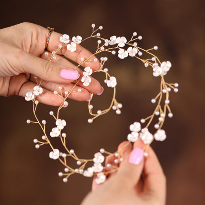 a woman holding a flower crown in her hands