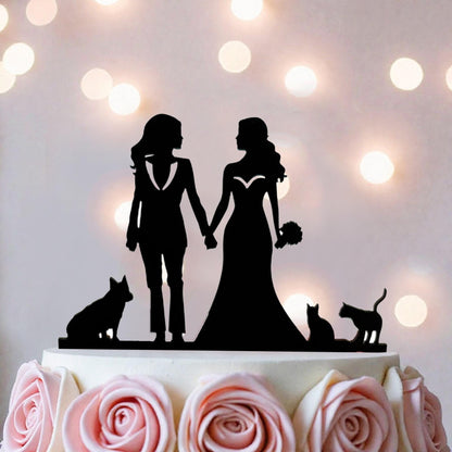 A silhouette of two women in wedding attire holding hands, with a dog and cat in the background, is the focus of the image.