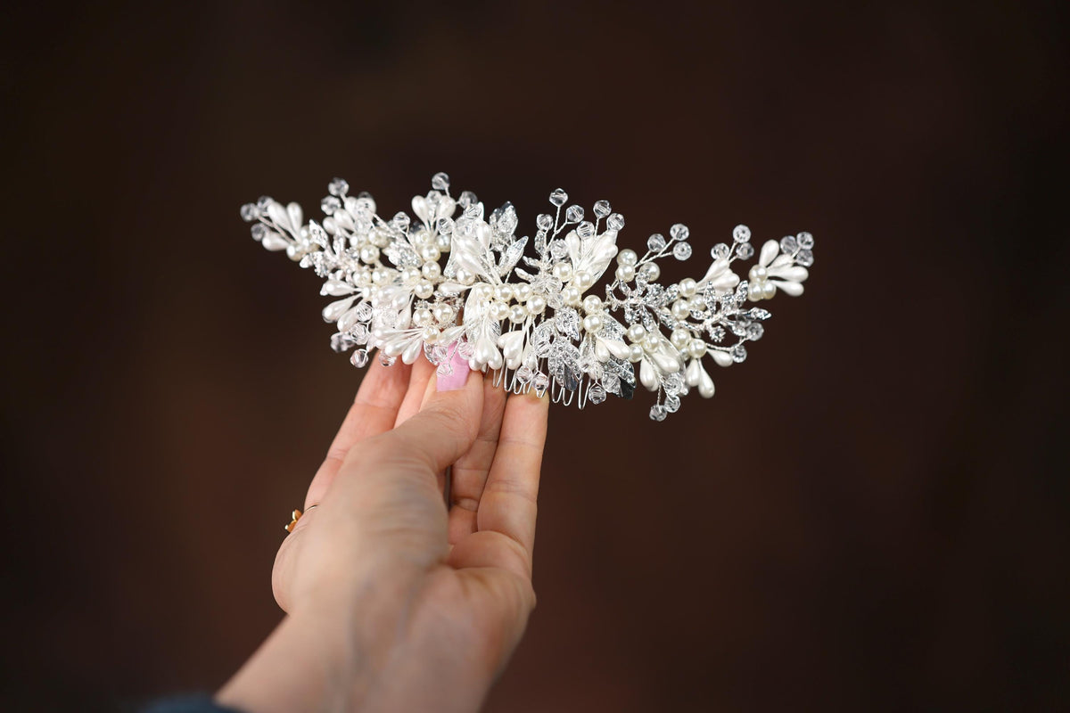 a person holding a white flower in their hand