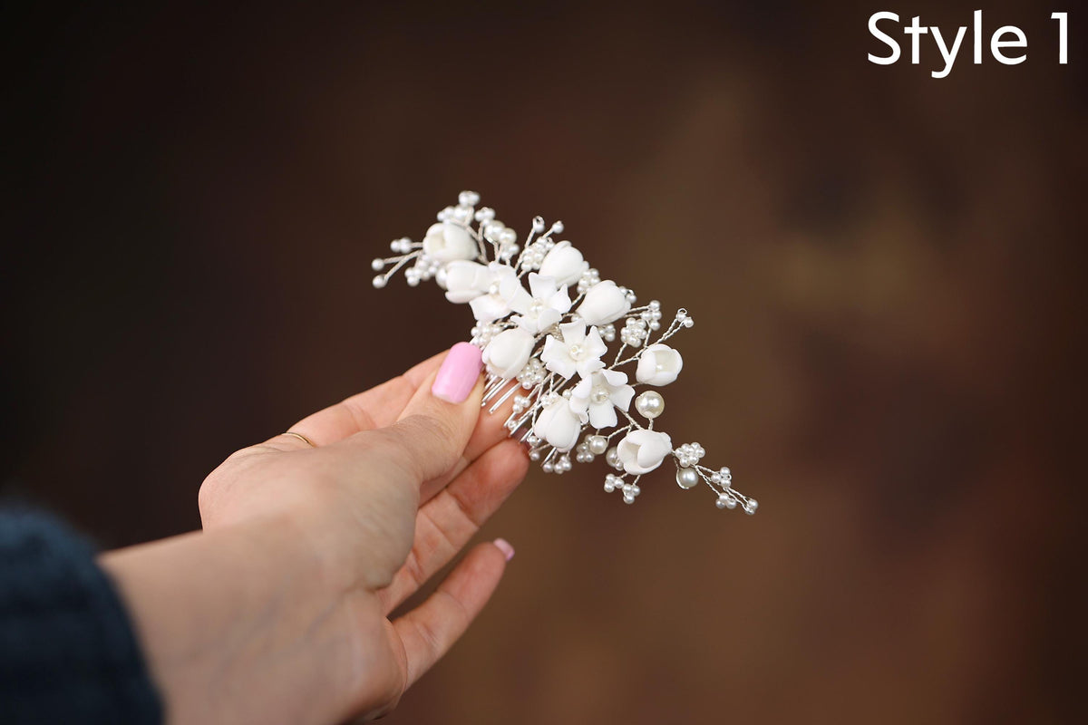 a person holding a small white flower in their hand