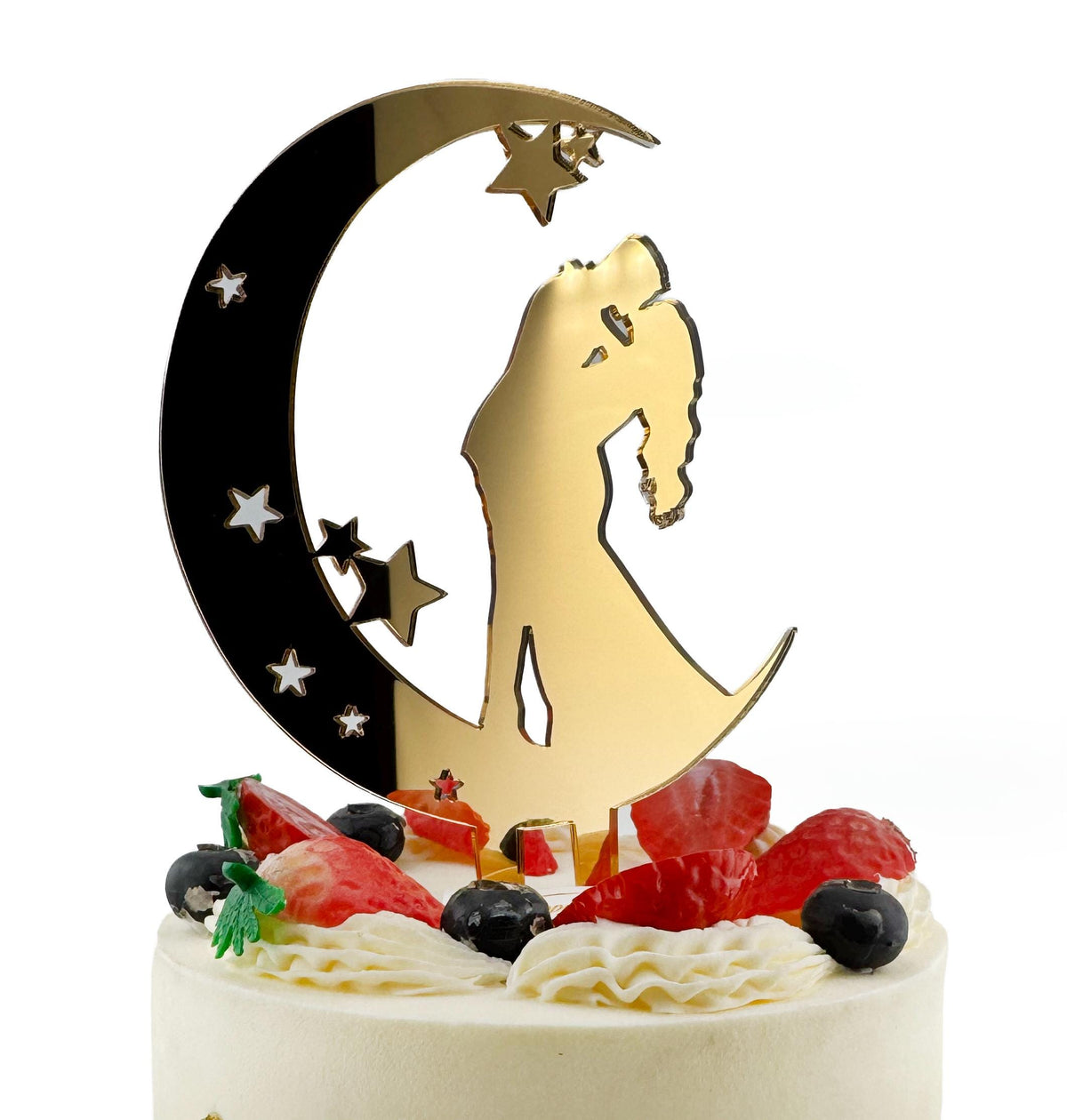 A white cake with a gold crescent moon and star-shaped decorations, including a silhouette of a couple embracing.