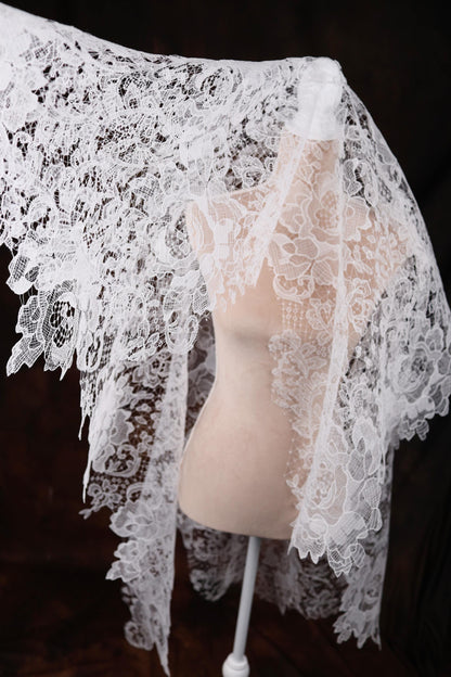a mannequin wearing a white lace shawl