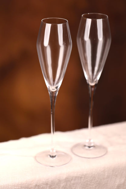 two wine glasses sitting on top of a table