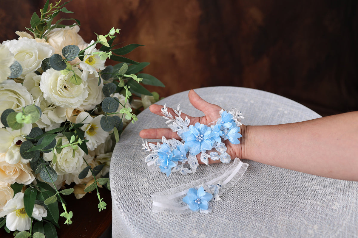 a woman's hand holding a bouquet of flowers on top of a table