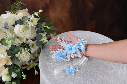 a woman's hand holding a bouquet of flowers on top of a table