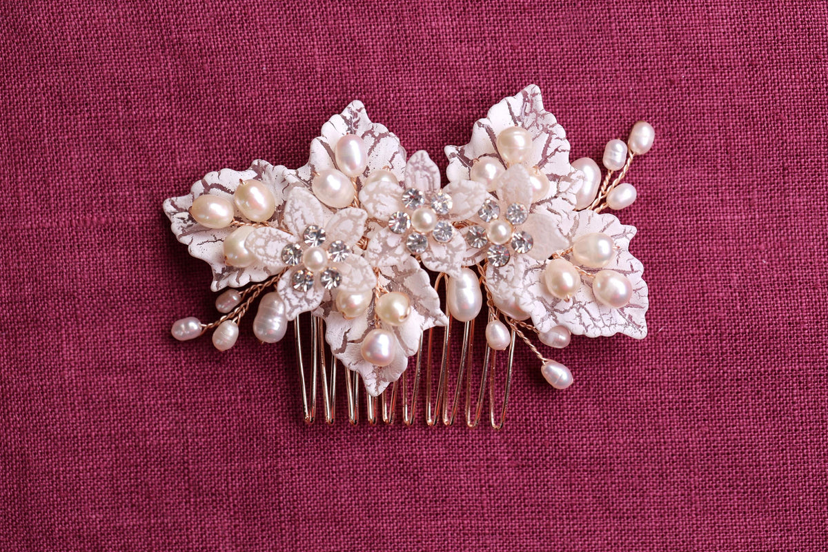 a close up of a hair comb with flowers and pearls