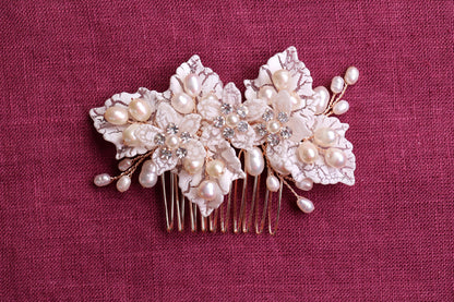 a close up of a hair comb with flowers and pearls
