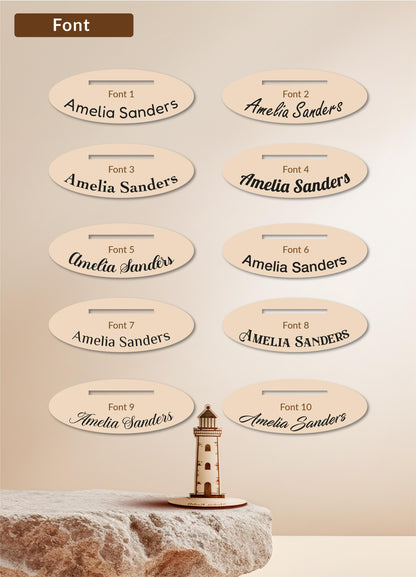 a collection of oval-shaped labels with the name "Amelia Sanders" written on them, placed on a stone surface.