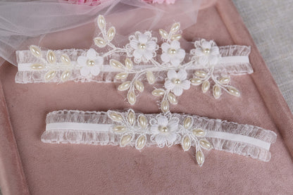 a pair of wedding garters with flowers on them