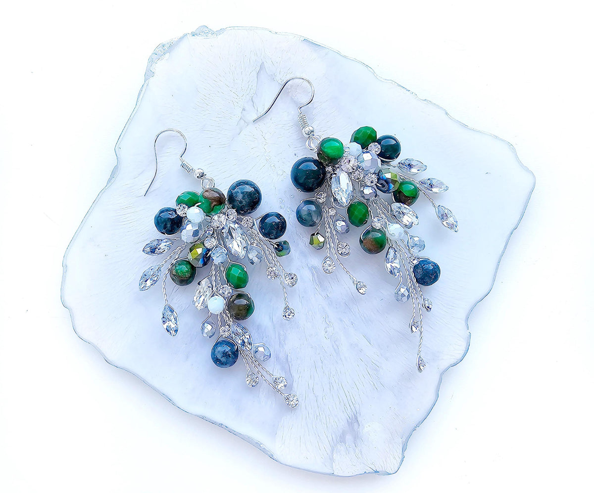 a pair of green and white beaded earrings