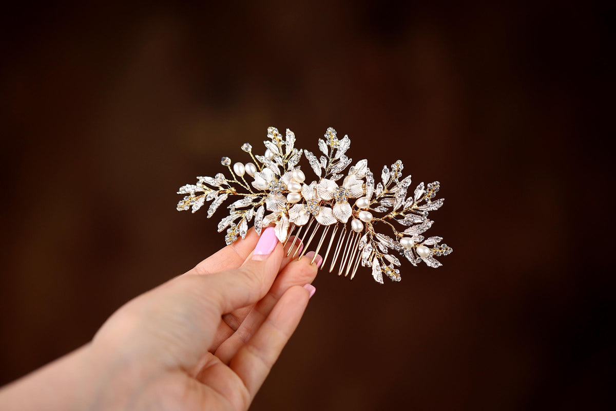a woman's hand holding a bridal hair comb