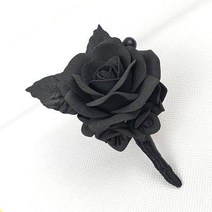 a single black rose on a white cloth