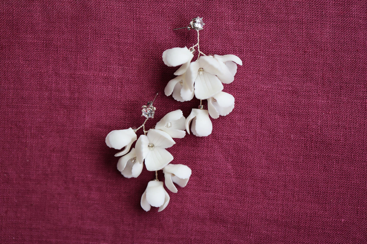 a pair of white flowers on a red cloth