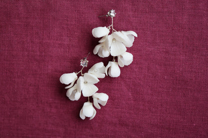 a pair of white flowers on a red cloth