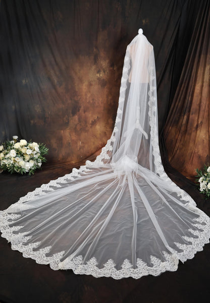 a white wedding veil with lace on it