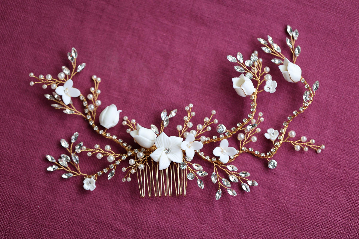 a hair comb with flowers and leaves on it