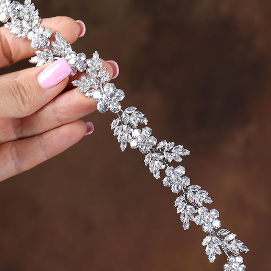 a close up of a person holding a tiara
