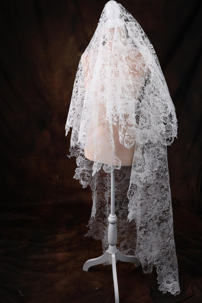 a mannequin wearing a white veil on a black background