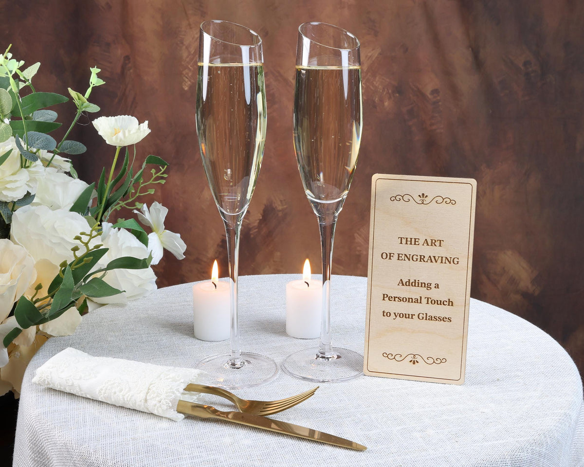 a table with two glasses of champagne and a sign