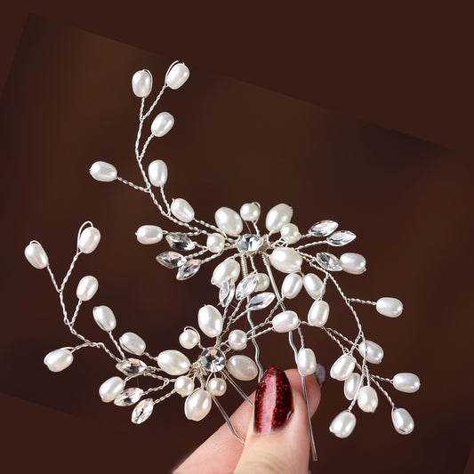 a hand holding a piece of jewelry with pearls on it