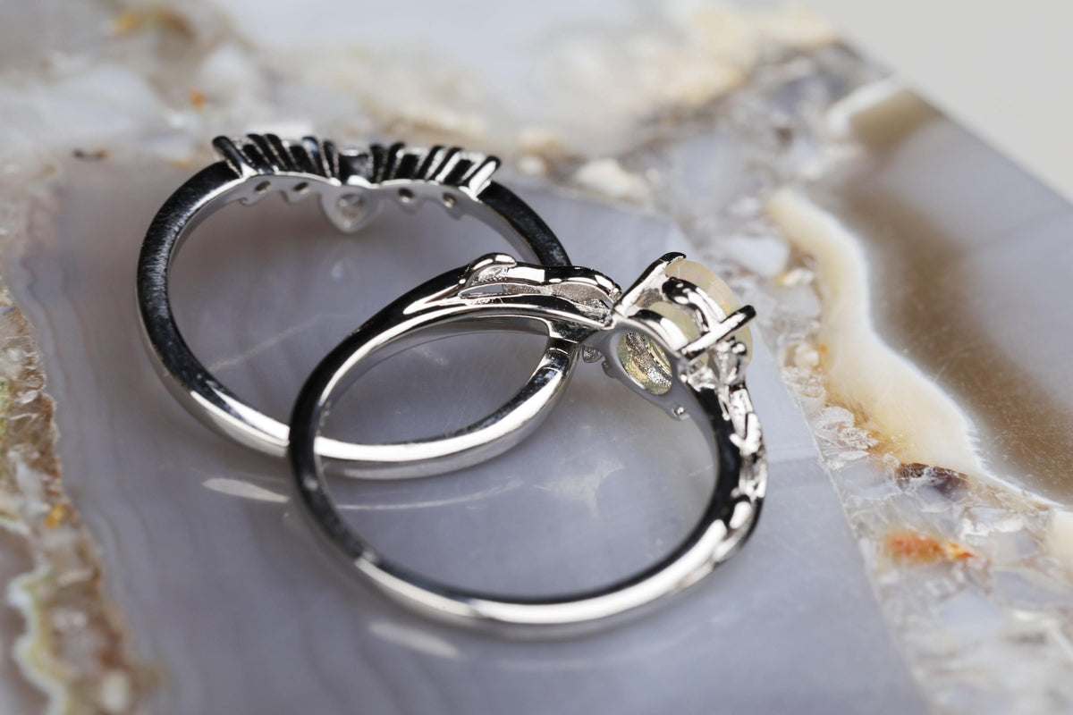 a couple of silver rings sitting on top of a table
