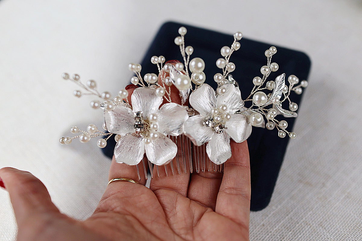 a person holding a hair comb with flowers on it
