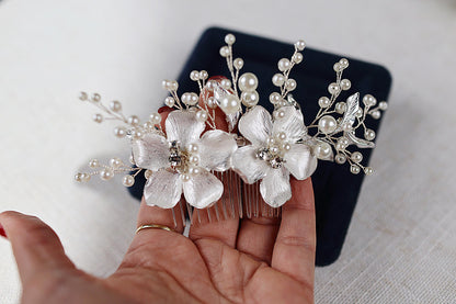 a person holding a hair comb with flowers on it