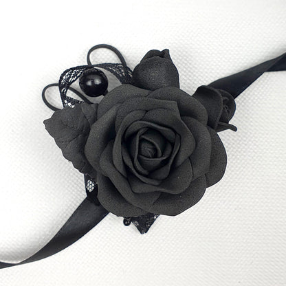 a black corsage with a black rose on it
