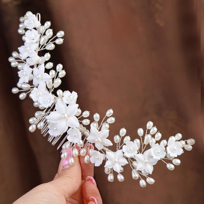 a woman is holding a bridal hair comb
