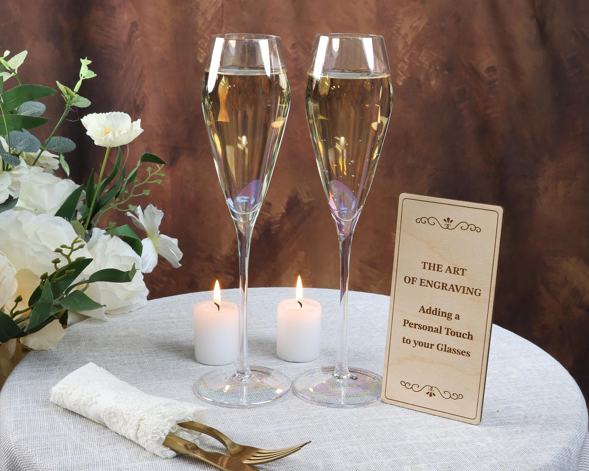 two champagne flutes sitting on top of a table