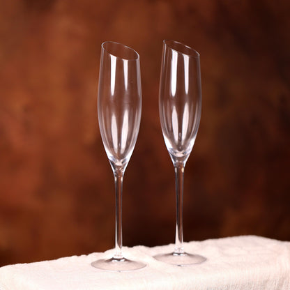 two wine glasses sitting on top of a white cloth