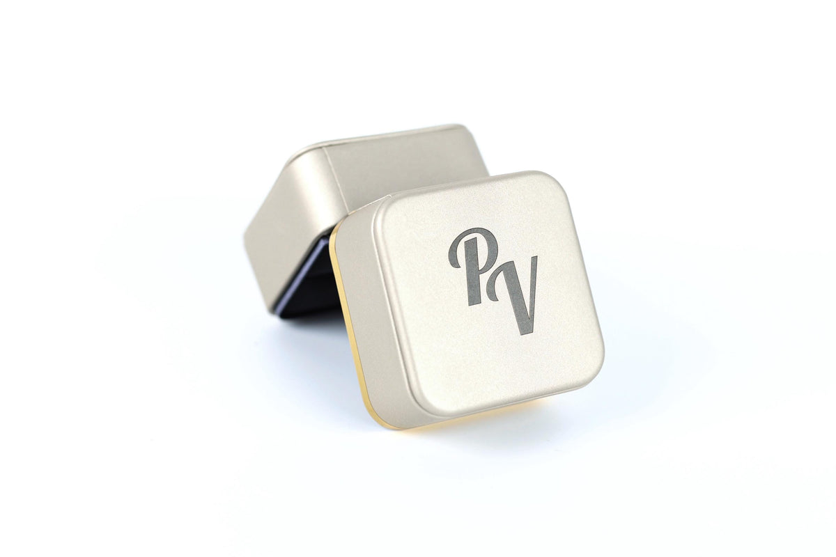 a square-shaped metal box with a logo on it.