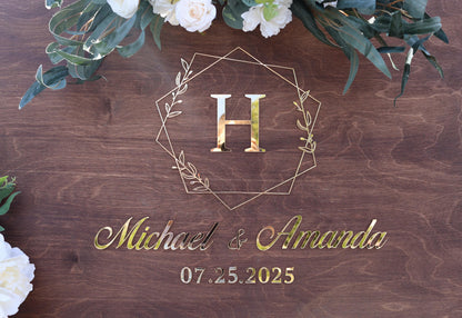a wooden sign with a floral arrangement on top of it