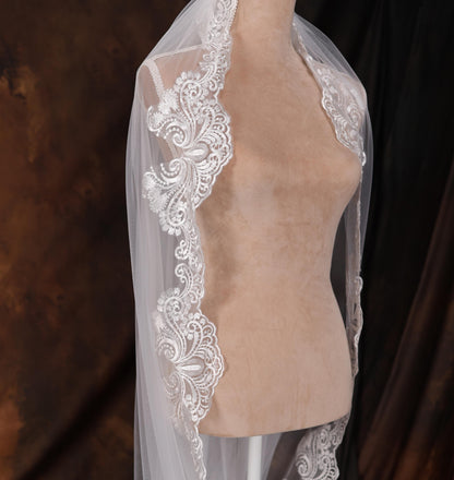 a mannequin with a white veil on top of it