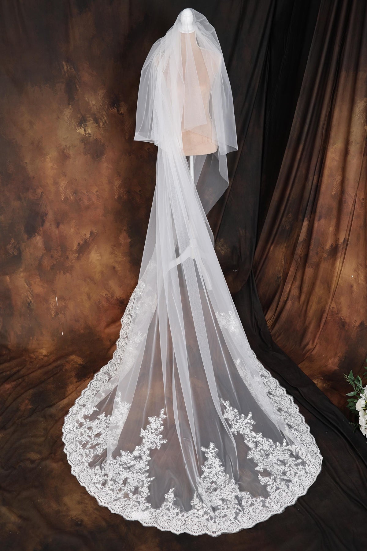 a wedding veil on a mannequin with flowers