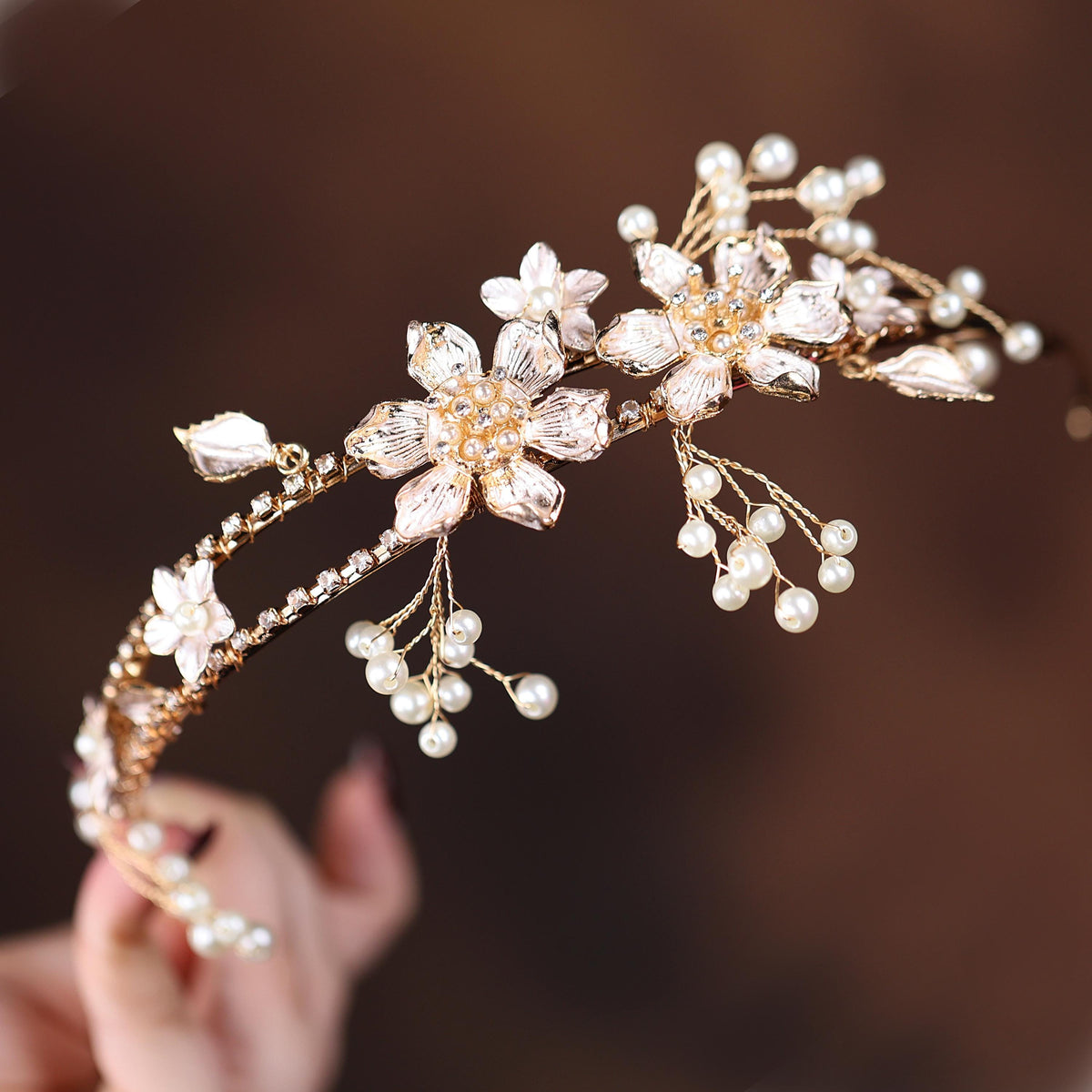 a close up of a person holding a tiara