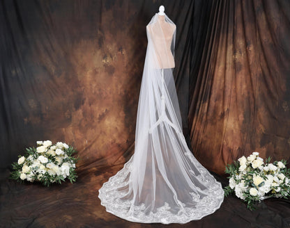 a wedding dress and veil on a mannequin