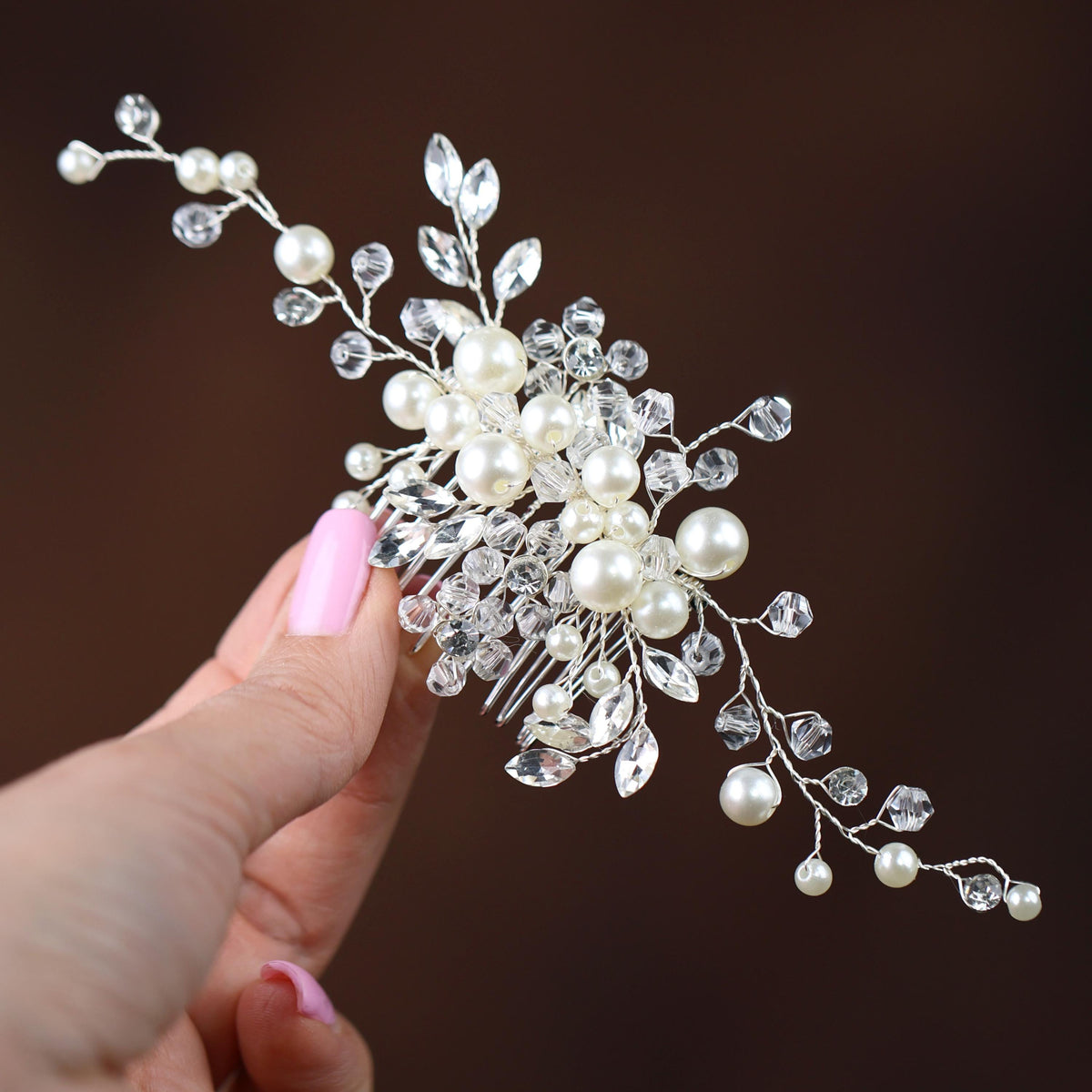 a close up of a person holding a hair piece