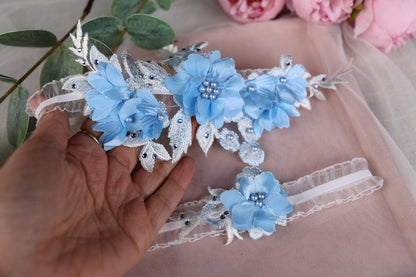 a hand holding a pair of blue flowers