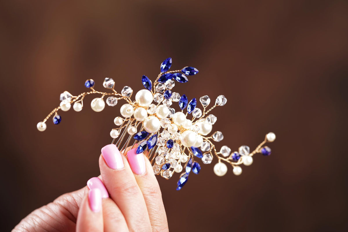 a close up of a person holding a hair comb
