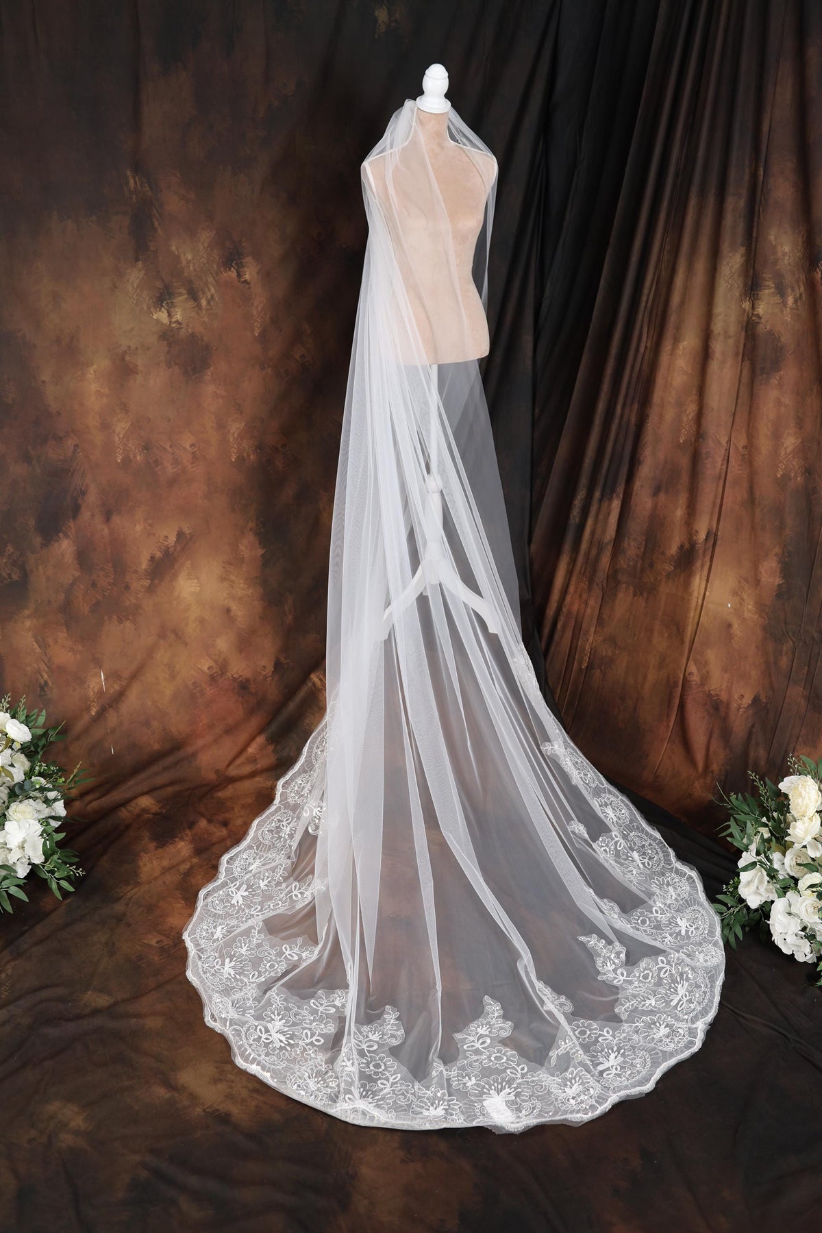 a wedding veil on a mannequin with flowers