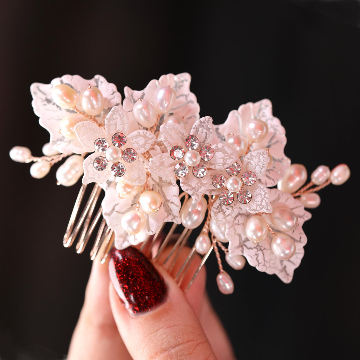 a close up of a person holding a hair comb